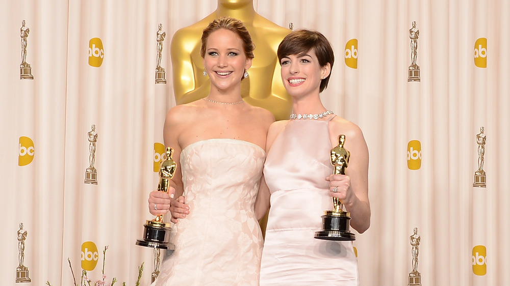 Jennifer Lawrence and Anne Hathaway pose with their awards at the 2013 Oscars