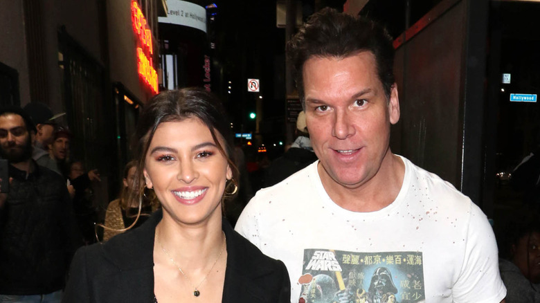 Kelsi Taylor and Dane Cook walking outside smiling.