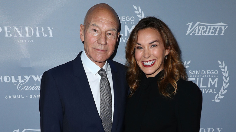 Patrick Stewart and Sunny Ozell posing at an event.