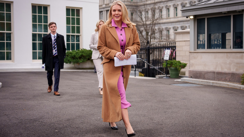 Karoline Leavitt smiles at photographers as she exits the White House.