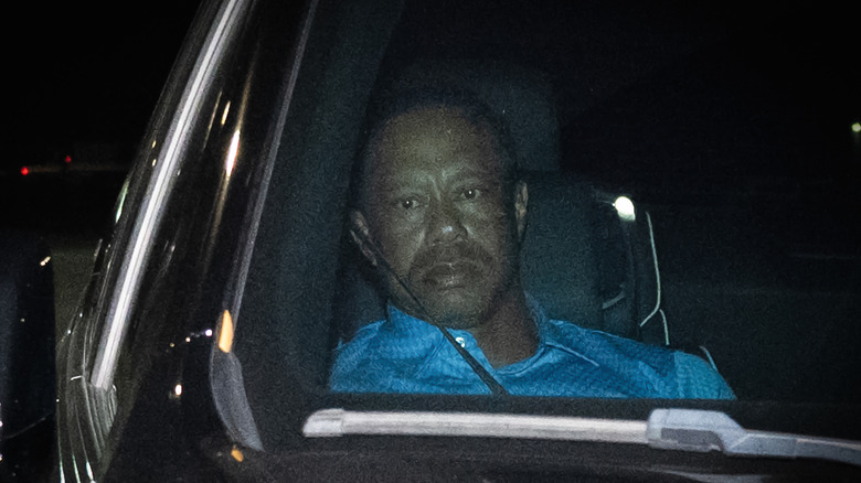 Tiger Woods sitting in a car after being arrested in 2026.
