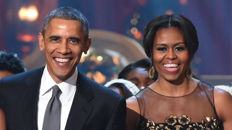 Barack Obama and Michelle Obama smiling for a photo