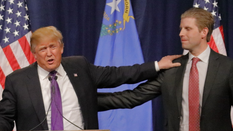 Donald touching Eric Trump shoulder