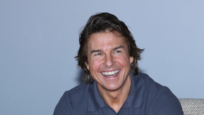 Tom Cruise blue collared shirt smiling