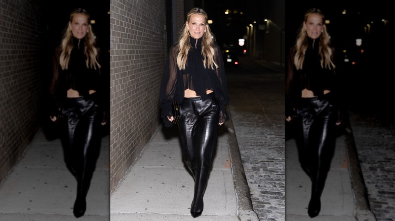 Molly Sims in an all-black outfit with a chiffon top and leather pants.