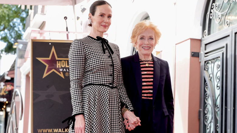 Sarah Paulson and Holland Taylor holding hands at Paulson's Hollywood Walk of Fame induction ceremony.