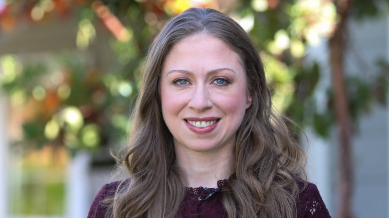Chelsea Clinton smiles outdoors