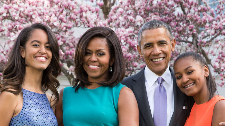 Malia, Michelle, Barack, and Sasha Obama smiling
