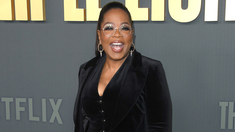 Oprah speaking animatedly on the red carpet.