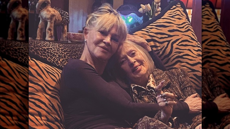 Melanie Griffith cuddling on a couch with her mom.