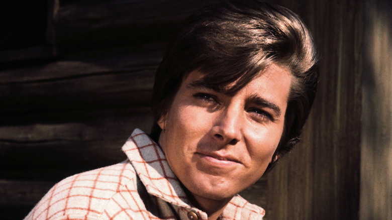 Bobby Sherman smiling and looking over his shoulder in his younger years.