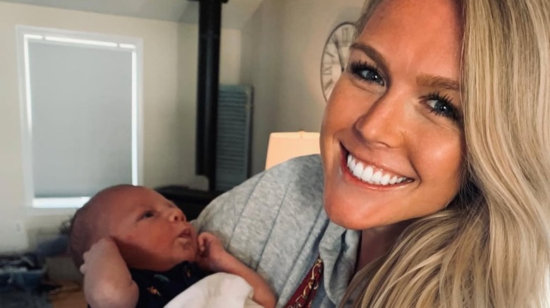 Karoline Leavitt smiling holding a baby
