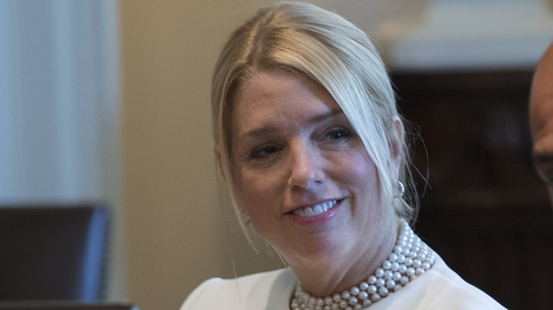 Pam Bondi listening to Donald Trump (not pictured) with a slight smile