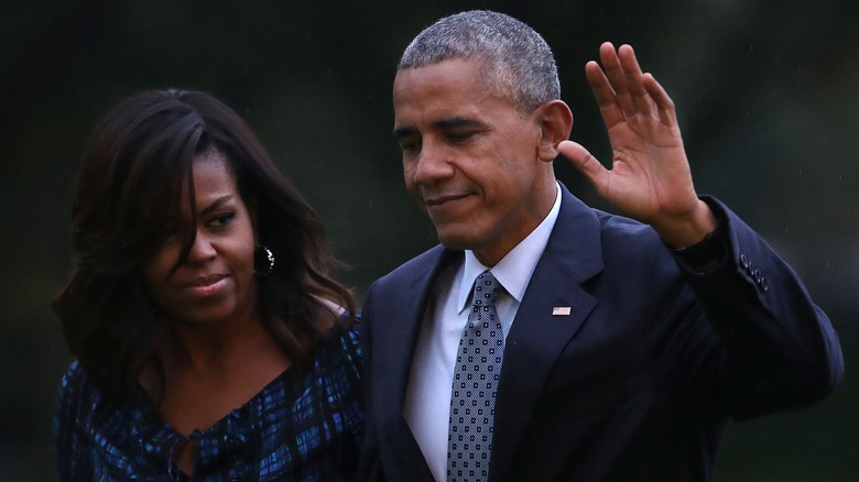 Barack Obama waves while walking with Michelle