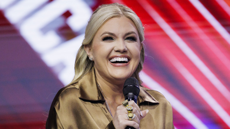 Erika Kirk laughing into microphone