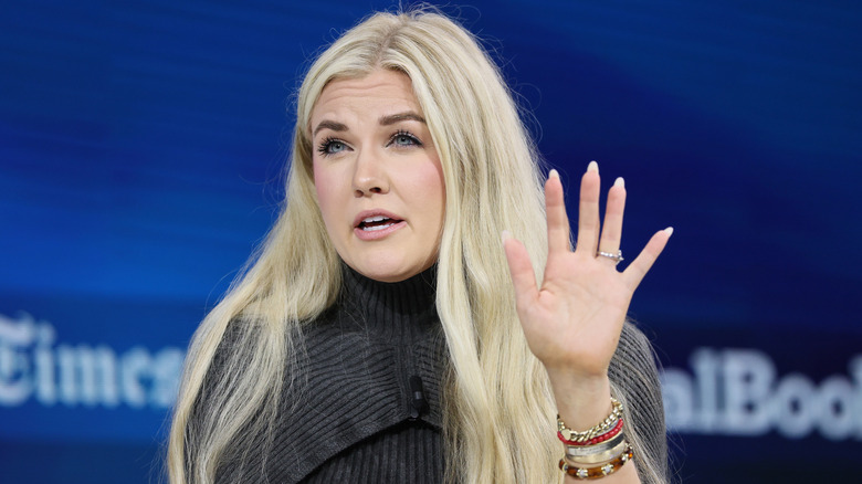 Erika Kirk talking while raising left hand