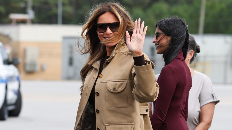 Melania Trump waving to photographers.