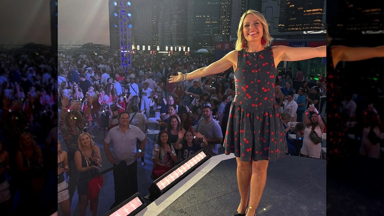 Dylan Dreyer smiling with arms out in front of big crowd