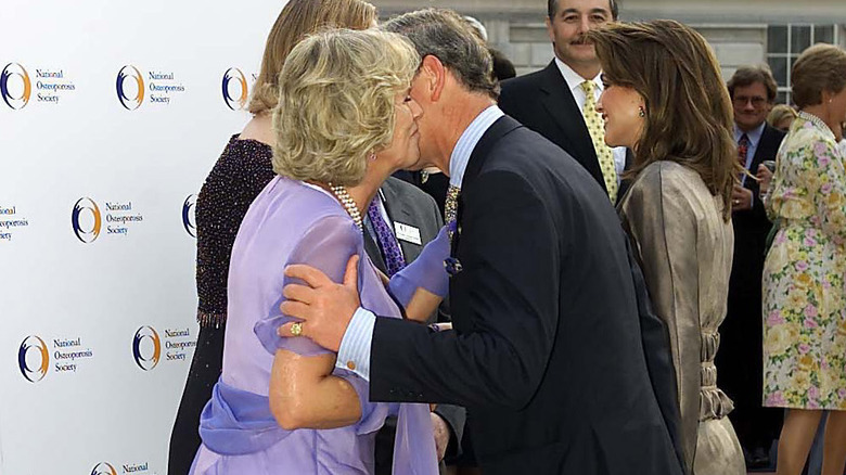Camilla gives Charles a kiss at Somerset House