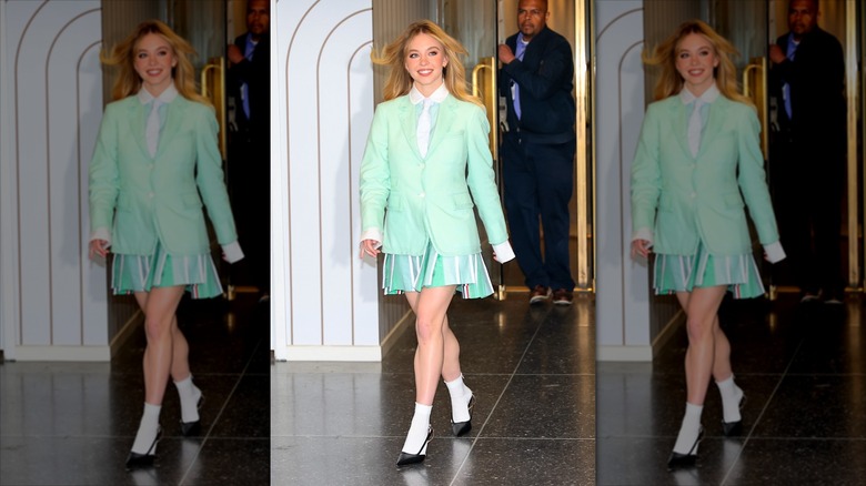 Sydney Sweeney smiling while walking