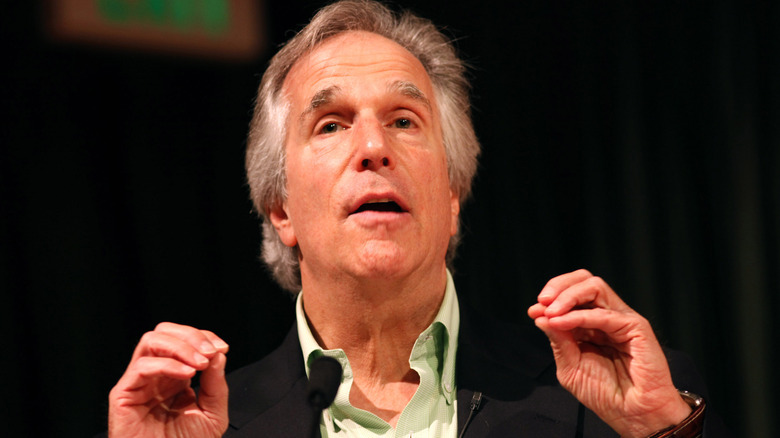 Henry Winkler holding hands up