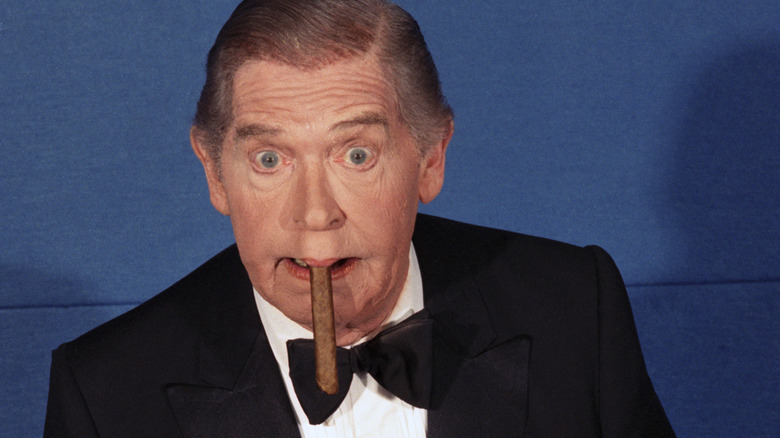 Milton Berle mugging for he camera with a cigar in his mouth