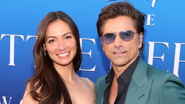 Caitlin McHugh and John Stamos at the World Premiere of "The Little Mermaid"