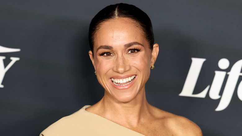 Meghan Markle smiling on the red carpet