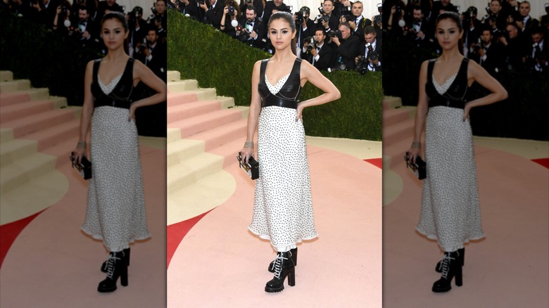 Selena Gomez at the 2016 Met Gala in a black harness-style top and white studded dress.
