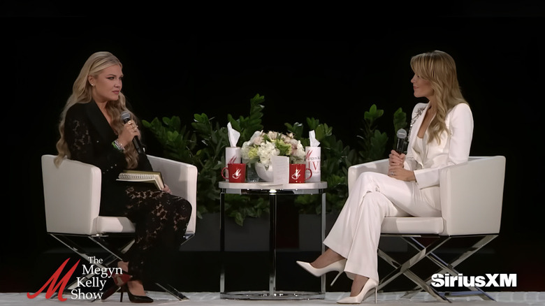 Erika Kirk sits with microphone in lace talking to Megyn Kelly