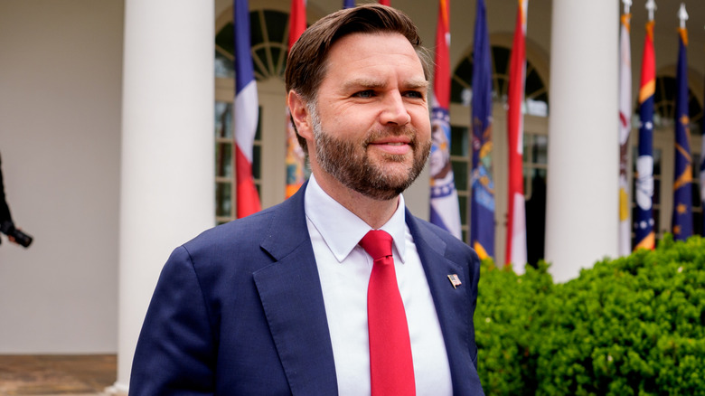 JD Vance walking down steps and smiling