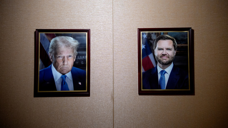 Portraits of Donald Trump and JD Vance on a wall in 2025