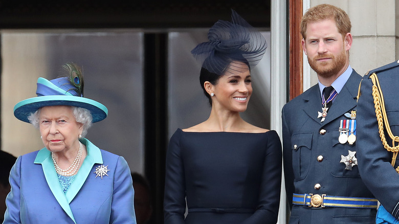 Queen Elizabeth II, Prince Harry, Duke of Sussex and Meghan, Duchess of Sussex on the balcony of Buckingham Palace.