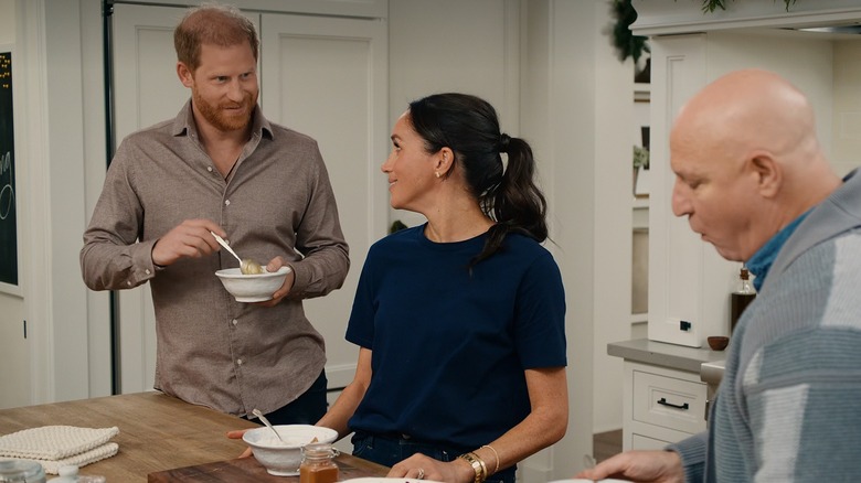 Meghan Markle looks back at Prince Harry as he eats from a bowl on "With Love, Meghan."