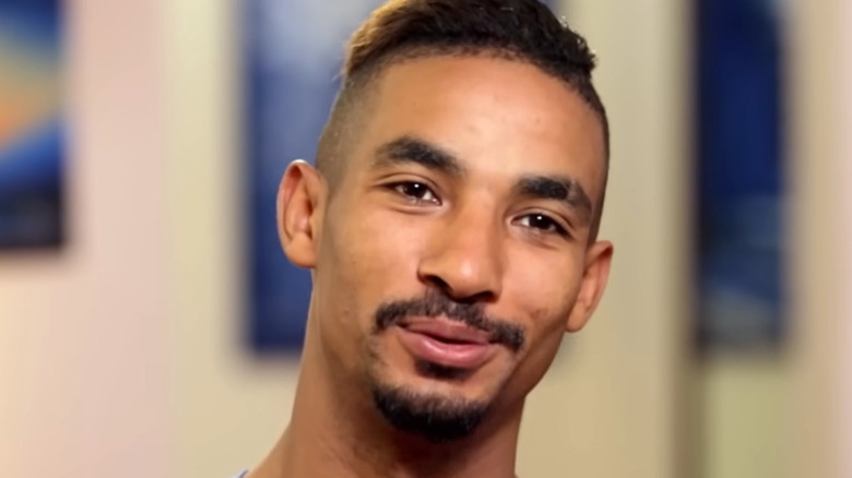 Azan Tefou from 90 Day Fiance smiles