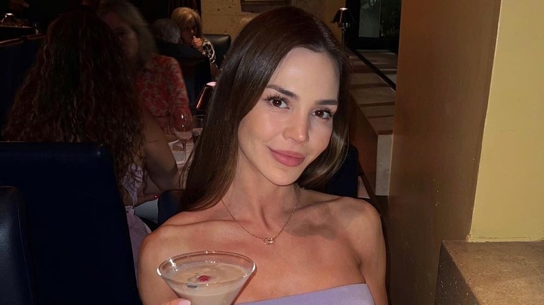 Anfisa Arkhipchenko smiling with drink