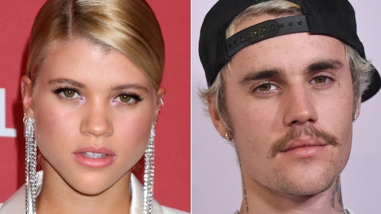 Sofia Richie posing, Justin Bieber in cap