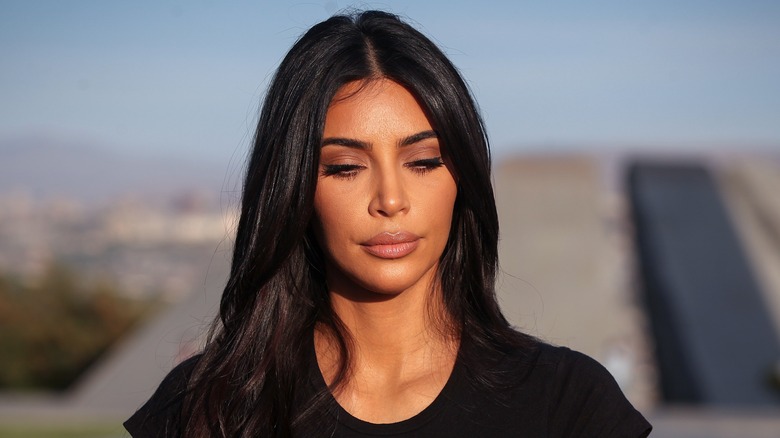 Kim Kardashian looking down