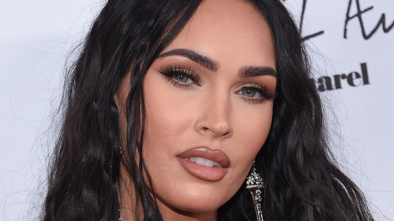 Megan Fox at an event, looking at camera