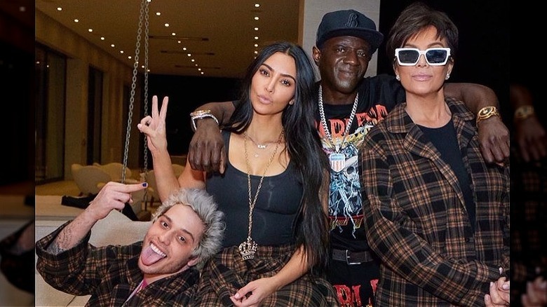 Kim Kardashian, Pete Davidson, Flavor Flav and Kris Jenner celebrating