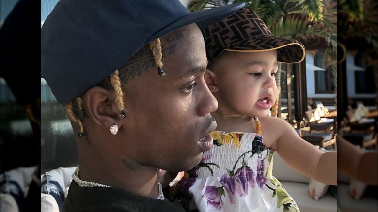 Travis Scott holding daughter on Instagram 