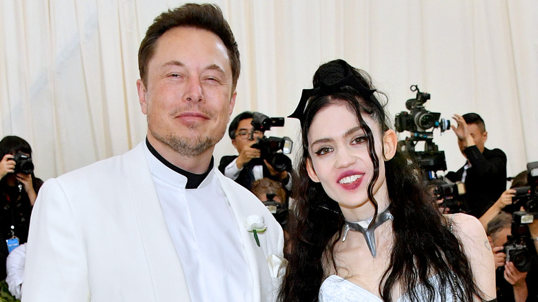 Grimes and Elon Musk pose in 2018