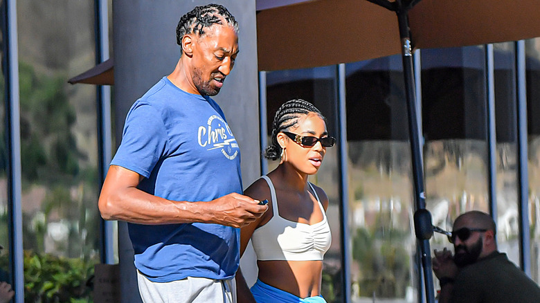 Scottie Pippen and a woman walk down a sidewalk