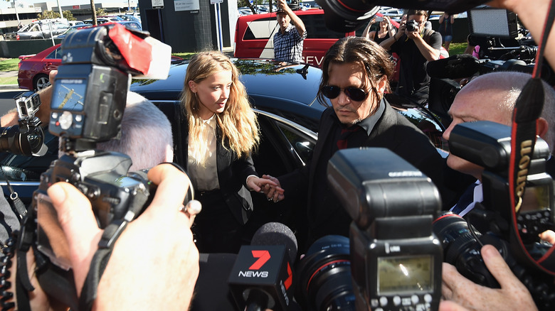 Amber Heard and Johnny Depp getting out of the car