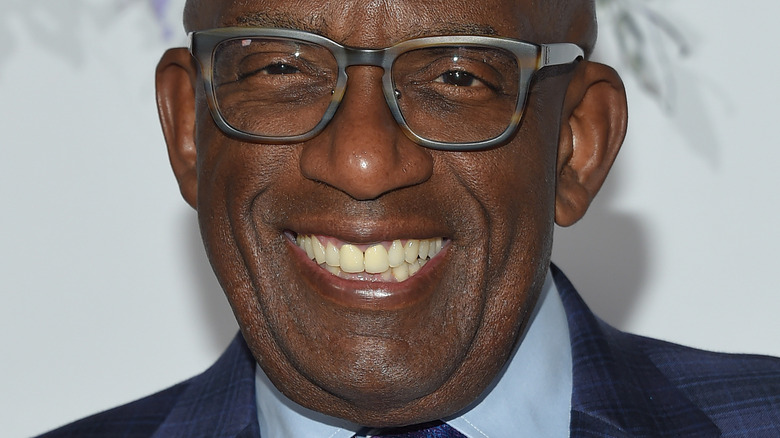 Al Roker smiles in thick-frame glasses