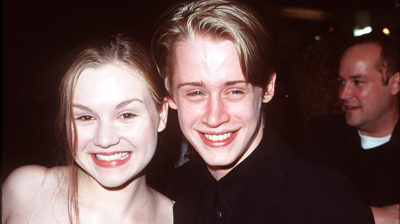 Rachel Miner and Macaulay Culkin grinning