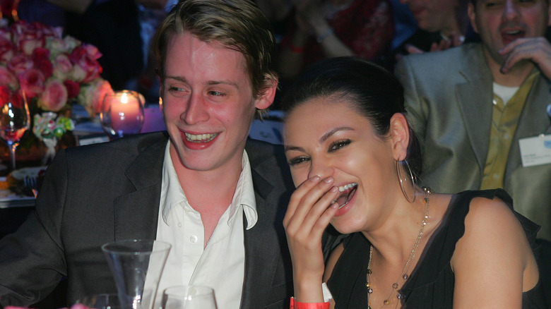 Macaulay Culkin and Mila Kunis laughing