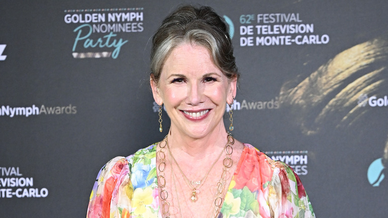 Melissa Gilbert smiles in a colorful floral gown