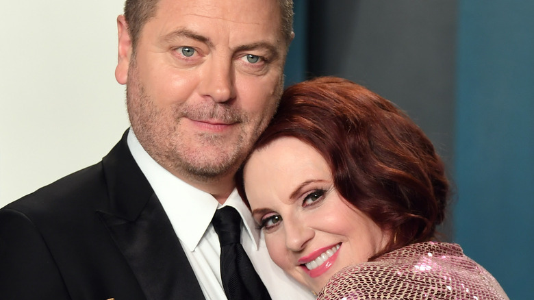 Nick Offerman and Megan Mullally cuddling on the red carpet
