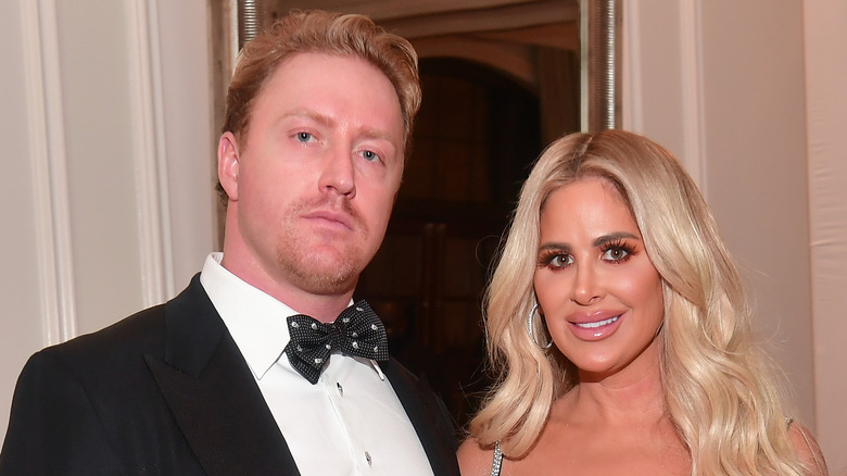 Kroy Biermann and Kim Zolciak-Biermann posing sadly